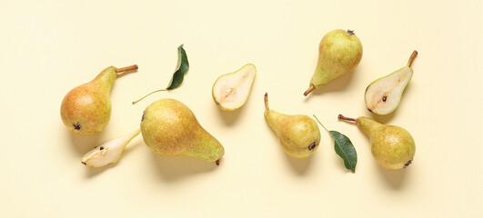 Ripe pears and leaves on yellow background