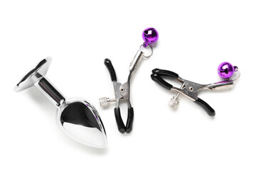 Purple nipple clamps and anal plug from sex shop on white background