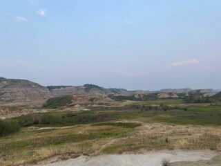 vast mountain views with blue bright sky and green fields. 