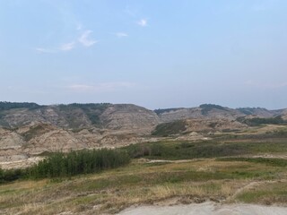 vast mountain views with blue bright sky and green fields. 