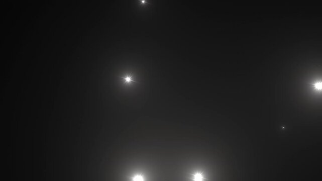 Photographer camera flashes. Random bright blinking lights. Flashing lens flares. Seamless looping.