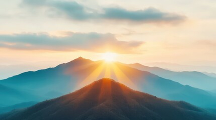 Obraz premium Majestic Mountain Sunrise with Golden Rays and Dramatic Sky