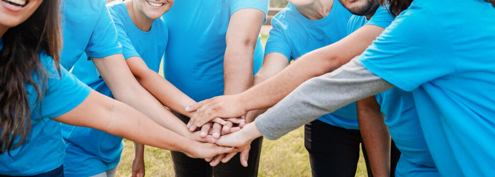 Volunteer, Team people stacking hands celebrating together. Charity and environmental community project