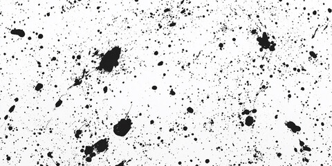 Fototapeta premium Black ink splattering on white background creating abstract design