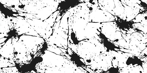 Fototapeta premium Black ink splattering on white background creating abstract design