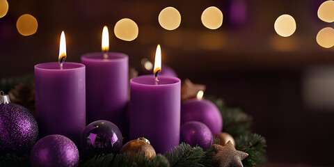 Burning advent candles with purple christmas ornaments and bokeh lights creating festive atmosphere