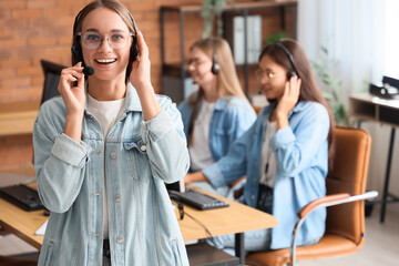 Female technical support agent with headset in office