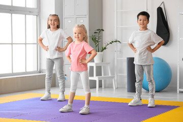 Fototapeta premium Cute little children training in gym