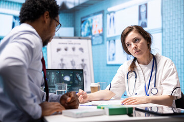 Medical expert prescribing medicaments and drugs with the right dosage, signing a prescription for antibiotics and receipt. Physician recommending pills and vitamins on health insurance.