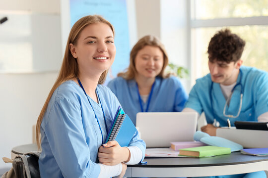 Female medical student with notebooks studying at university