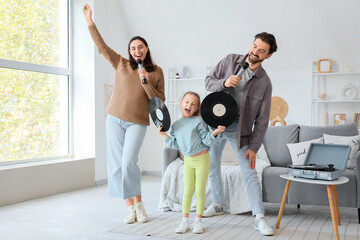 Happy family with microphones and vinyl disks singing karaoke at home