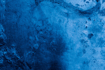 Grunge classic blue concrete background. Textured plaster wall. Creative backdrop for your design. Color of the year 2026 concept. Top view, layout for design. Surface with peeling shabby pattern.