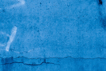 Grunge classic blue concrete background. Textured plaster wall. Creative backdrop for your design. Color of the year 2026 concept. Top view, layout for design. Surface with peeling shabby pattern.
