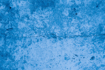Grunge classic blue concrete background. Textured plaster wall. Creative backdrop for your design. Color of the year 2026 concept. Top view, layout for design. Surface with peeling shabby pattern.