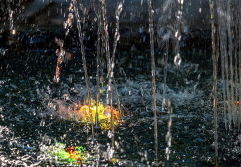 Fountain with colored backlight close-up.