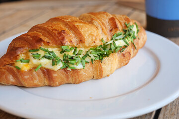 Amouthwatering and delicious Croissant Sandwich filled with Fresh Herbs and Eggs