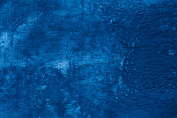 Grunge classic blue concrete background. Textured plaster wall. Creative backdrop for your design. Color of the year 2026 concept. Top view, layout for design. Surface with peeling shabby pattern.