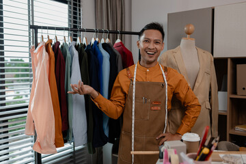 a fashion designer is in his studio and shows off a variety of poses, a tailor poses for photos, expressing different feelings in the fashion room, stylish, clothes, fashionable, textile