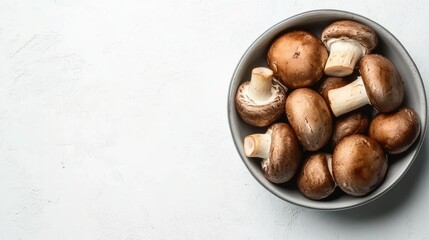 Obraz premium Fresh Brown Mushrooms in a Bowl on White Background