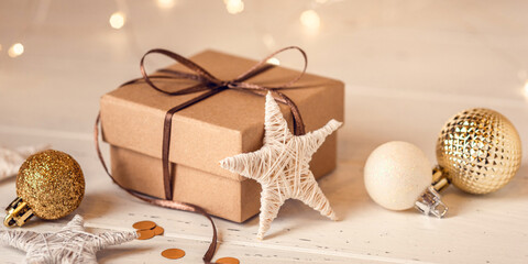 Christmas gift box and decorations on white wooden table. Front view.