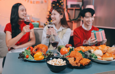 Friends opening Christmas gifts in living room