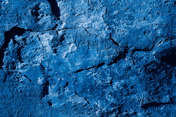 Grunge classic blue concrete background. Textured plaster wall. Creative backdrop for your design. Color of the year 2026 concept. Top view, layout for design. Surface with peeling shabby pattern.