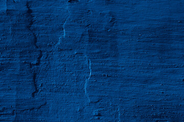 Grunge classic blue concrete background. Textured plaster wall. Creative backdrop for your design. Color of the year 2026 concept. Top view, layout for design. Surface with peeling shabby pattern.