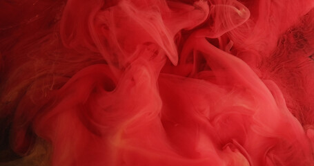 Color vapor. Ink cloud. Red paint water mist floating texture on dark black glitter particles abstract art background.