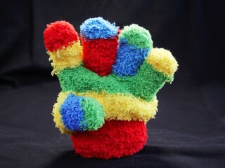 
Glove of a child's hand that counts and raises fingers. A countdown or addition of a hand that makes the gesture of arithmetic. Child's lost glove.