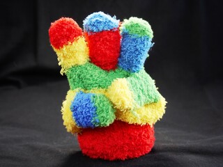 
Glove of a child's hand that counts and raises fingers. A countdown or addition of a hand that makes the gesture of arithmetic. Child's lost glove.