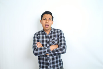 confused asian man looking at camera with folded arm wearing casual plaid shirt isolated on white background