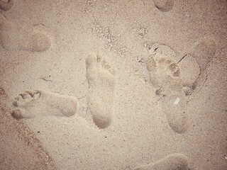 Foot on brown sand beach