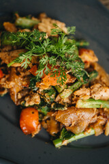A plate of Thai flat noodles with chicken