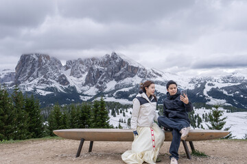 Couple vacation in Alpe di Siusi mountain group in Dolomites, Italy.