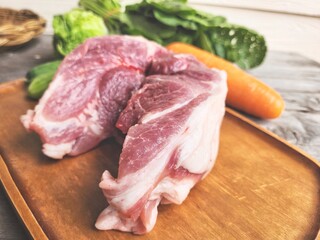 Raw pork and vegetable on wood board