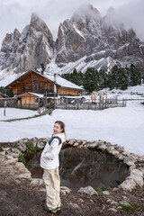 Woman enjoy the view of Geisler Alm, Adolf Munkel Trail, Nature Park, Dolomites Italy.