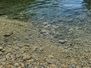 Sea crystal clear water on pebble beach