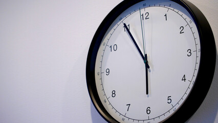 A classic wall clock displays the current time, emphasizing the importance of time management in daily life. The clock ticks rhythmically, serving as a reminder to value each moment.