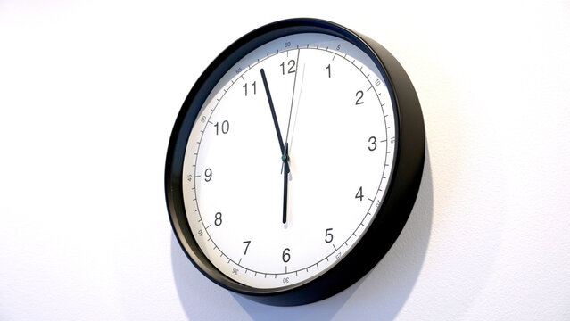 A clear view of a wall clock displaying the hour, minute, and second hands. This piece highlights the importance of tracking time for effective time management and productivity.