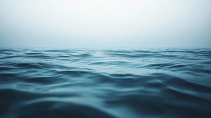 Fototapeta premium serene view of calm ocean waves under soft, misty horizon, evoking tranquility and peace. gentle ripples create soothing atmosphere