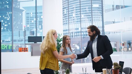 Portrait of cheerful financial advisor in office meeting with parent and child to provide...