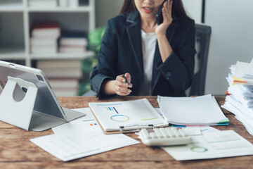 Focused Businesswoman on a Call: A detail-oriented businesswoman is deeply engrossed in a phone...