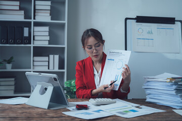 Businesswoman Presenting Data: A focused businesswoman in a red blazer passionately presents data from a document, showcasing her expertise and professionalism.