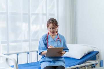 Compassionate Care: A female doctor attentively reviews patient notes on a clipboard, exuding...