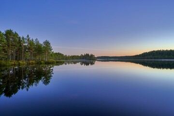 Serene dusk lake landscape with reflections.