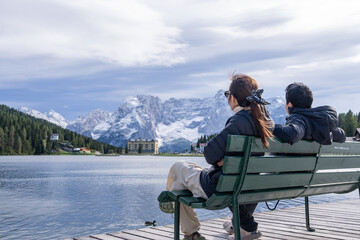 Couple enjoy view of Lago di Misurina - Misurina Lake winter season Dolomiti , Italy