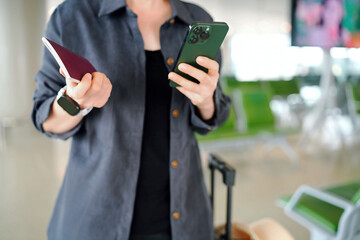 Preparing for Adventure: A Traveler at the Airport with Smartphone and Passport