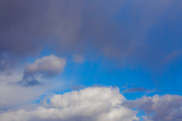 White heap clouds in the blue peaceful sky. The concept of psychological calmness and health. Peace of mind with the forces of nature. Air travel concept.