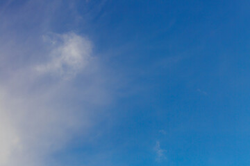 Fototapeta premium White heap clouds in the blue peaceful sky. The concept of psychological calmness and health. Peace of mind with the forces of nature. Air travel concept.