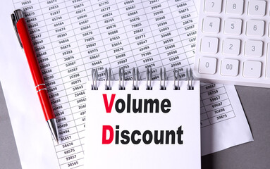 Volume discount concept with notebook, calculator, red pen, and numerical data on a desk